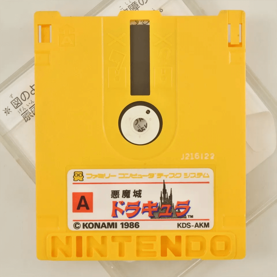 A bright yellow Famicom disk with an Akumajō Dracula label on it.